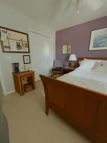 a bedroom with a large bed and a chair at Lawrence Loft in Lawrence