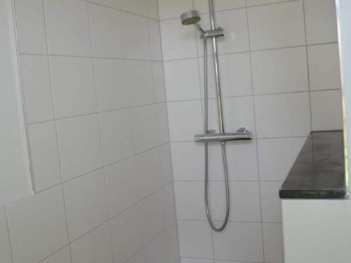 a shower with a shower head in a bathroom at Holiday Home Breskens near the Coast in Breskens