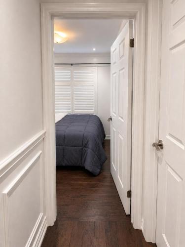 a bedroom with a bed in the middle of a hallway at The Quiet Nest in Mississauga