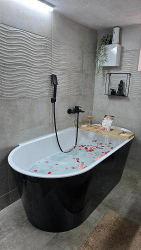 a bath tub with flowers on it in a bathroom at Nebeska Terasa in Knić