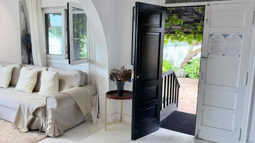 a living room with a white couch next to a door at Cabanas da Auga A in A Telleira