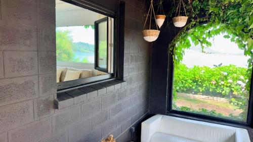 a bathroom with a window and a white sink at Cabanas da Auga A in A Telleira