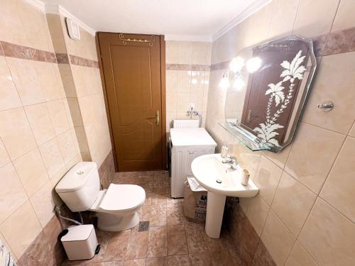 a bathroom with a toilet and a sink at Alexandros House in Néa Tríglia