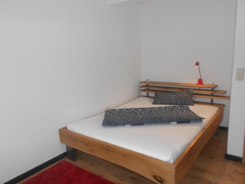 a bed with two pillows on it in a room at Ferienunterkünfte Deinhardt in Poxdorf