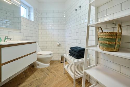 a white bathroom with a toilet and a sink at Villa Balaton in Balatonmáriafürdő