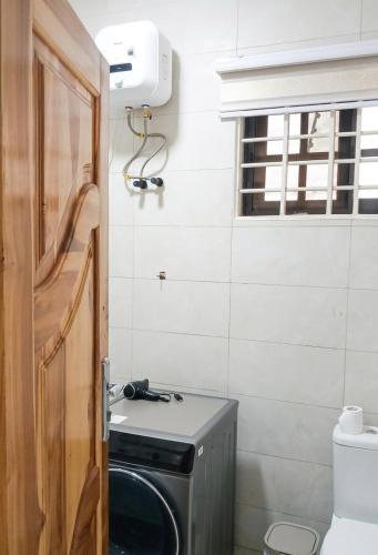 a small bathroom with a stove and a window at The Crest at Oyarifa in Oyarifa