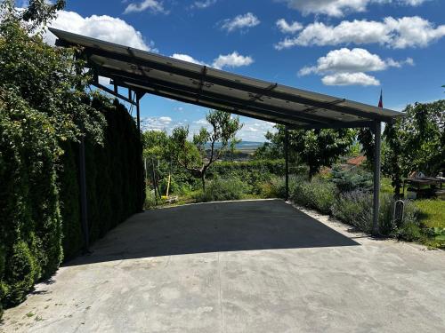 a parking lot with a metal canopy in a driveway at Mountain Panorama Garden BBQ ECO in Shumen