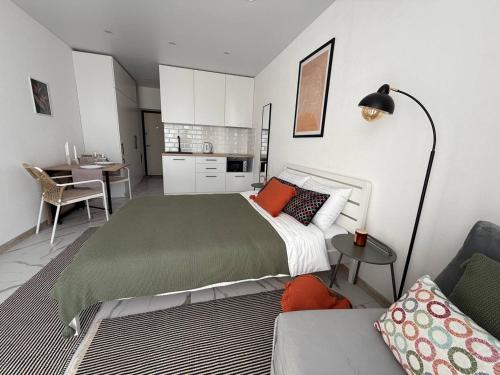 a bedroom with a large bed and a couch at Смарт хаус in Yuzhne