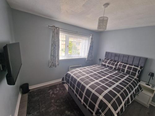 a bedroom with a bed and a window at wyvis stays in Inverness