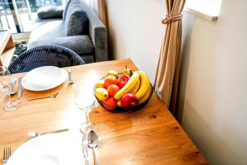 a bowl of fruit on a wooden table at Luxury Apartment Mara in Sukošan