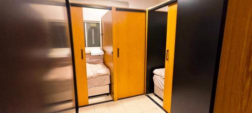 a small room with two doors and a small closet at La Casa Beduina Hostel in Riyadh