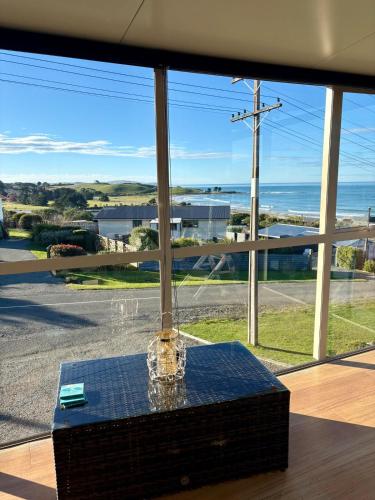 a large window with a view of the ocean at Ocean view on Semple in Kakanui