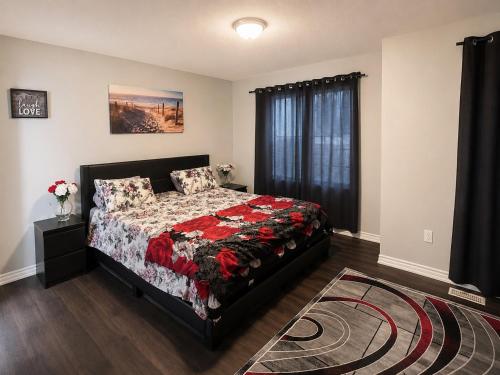 a bedroom with a bed and a window at Gifted Beautiful Home in Brampton