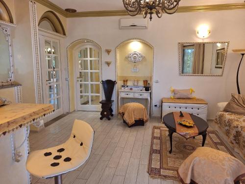 a room with a bed and a table and a mirror at DolceMorfeo in Olbia