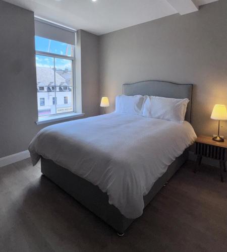 a bedroom with a large bed and a window at Studio 4 in Portadown