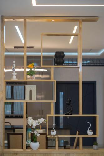 an office with a wooden shelf with flowers on it at Villa BOCANIA in Cotonou