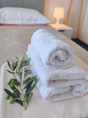 a pile of towels sitting on top of a bed at ĆOSIĆ APARTMANI IGRANE in Igrane