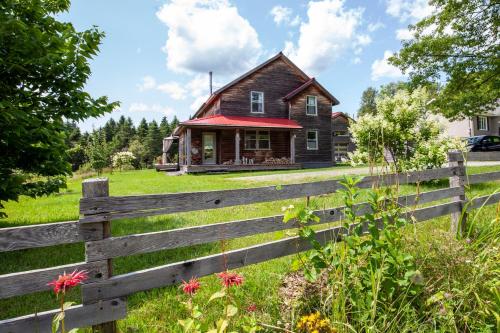 a wooden fence in front of a house at Spa Stukely in Eastman