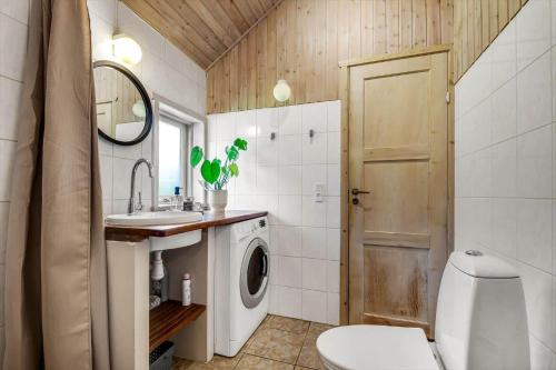 a bathroom with a sink and a washing machine at C11248-Hemmet-Ildervej-26 in Hemmet