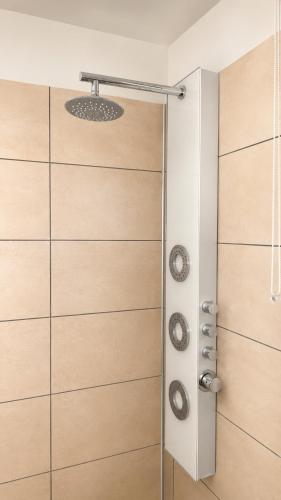 a shower with wooden doors in a bathroom at La Tanière Enchantée de Tréhorenteuc • Brocéliande in Tréhorenteuc