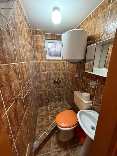 a small bathroom with a toilet and a sink at ADM Apartment in Bečići