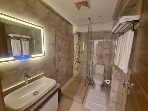 a bathroom with a sink and a shower and a toilet at Boutique Hotel El Mesaadia in Cairo