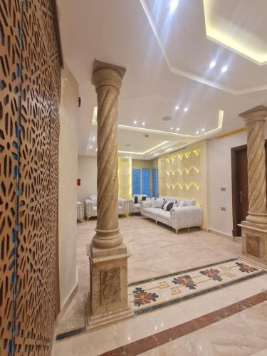 a large living room with a pillar and a couch at Boutique Hotel El Mesaadia in Cairo