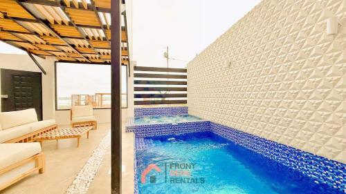 a swimming pool in the middle of a living room at Beachfront Escape Pool Hot Tub and Fire pit in Montañita
