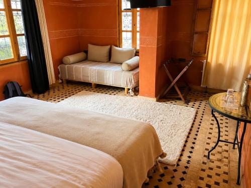 a living room with two beds and a couch at Dar Rihana Dadès in Aït Idaïr