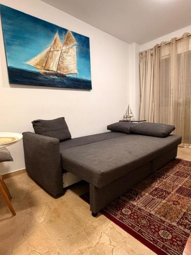 a bedroom with a bed and a painting of a yacht at Casaberian Manilva Beach Estepona, Marbella, Malaga, SPAIN in Manilva