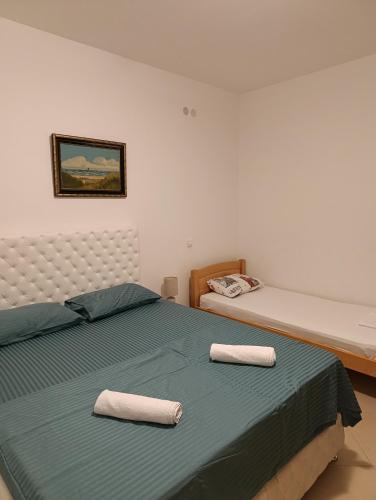 a bedroom with a bed with two towels on it at Lustica-Apartment Dora3 in Herceg-Novi