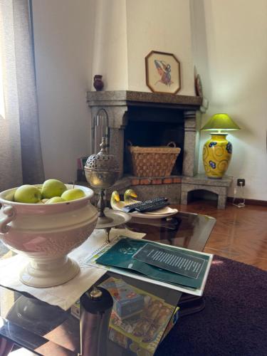 a living room with a table with a bowl of fruit at Casa Vicente in Lamego