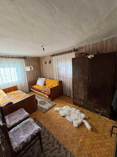 a living room with two beds and a couch at Etno kuća Močioci in Ivanjica