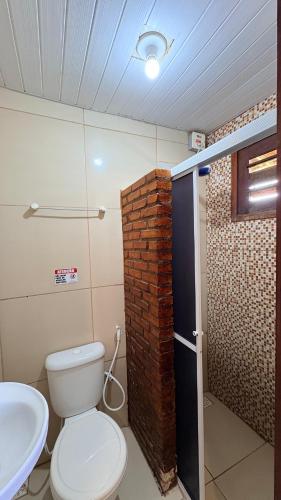 a bathroom with a toilet and a sink at Pousada Recanto das Fontes in Beberibe