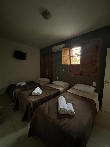 a room with three beds with towels on them at Casa UNO in San Rafael