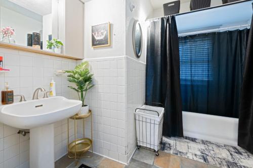 a bathroom with a sink and a shower curtain at Uptown Merchant in Abilene