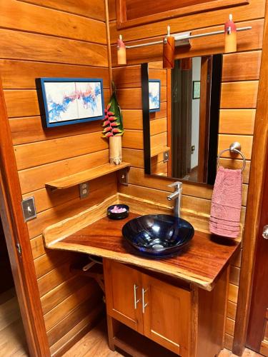a bathroom with a sink and a mirror at Kliffstone Jungle House in Sayab Camp