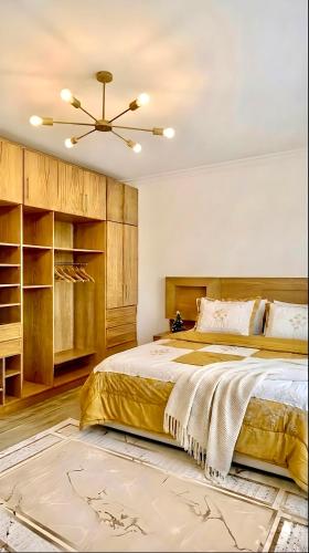 a bedroom with a bed and a ceiling fan at Modern Flat at Shiekh Zayed in Sheikh Zayed