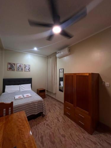 a bedroom with a bed and a ceiling fan at casa sol de sauce in Sauce