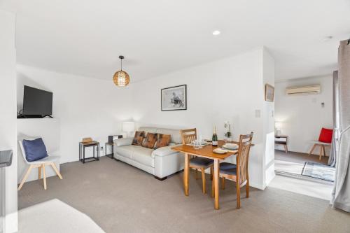 a living room with a table and a couch at Modern-Immaculate-Spacious-Comfy Beds-Private in Westport