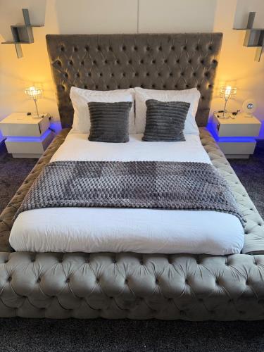 a bedroom with a large bed with two night stands at GS Maisons Hideaway in Sheffield