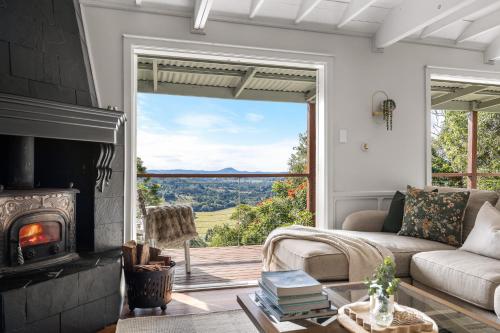 a living room with a couch and a fireplace at Misty Valley Cottage in Mapleton