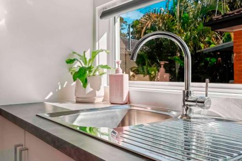 a sink in a kitchen with a window at Private Modern Bungalow - Separate Entry in Brisbane