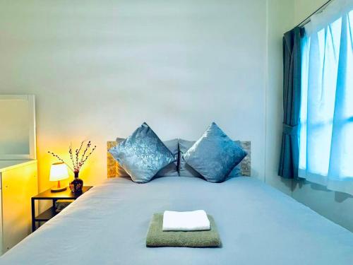 a bedroom with a bed with blue pillows at 幸 in Osaka