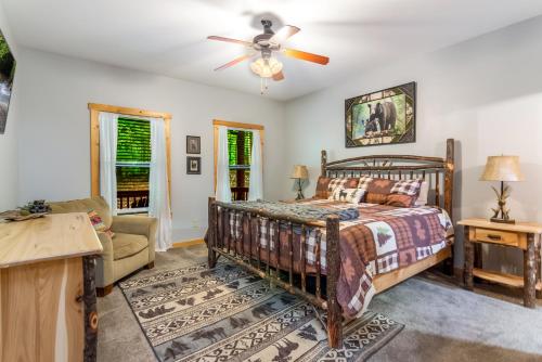 a bedroom with a bed and a ceiling fan at Quiet mornings and golden hour views welcome to our woodland sanctuary Deer Watch Retreat in Ellijay