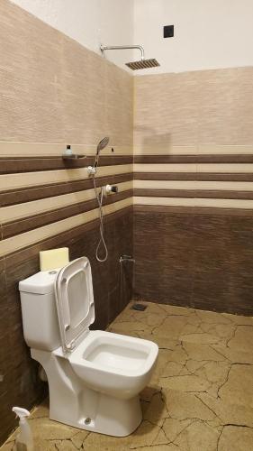 a bathroom with a toilet in a room at Surf and stay A- Bay in Arugam Bay