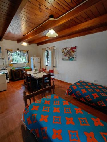 a bedroom with a bed with a blue comforter at La Quebrada del Molle in San Marcos Sierras