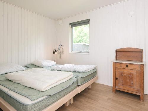 two twin beds in a room with a window at 4 star holiday home in Ørsted-By Traum in Ørsted