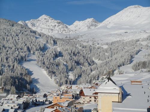 a town in the snow with mountains in the background at Haus Anemone in Serfaus