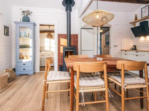 a dining room with a wooden table and chairs at 4 star holiday home in Hemmet in Hemmet